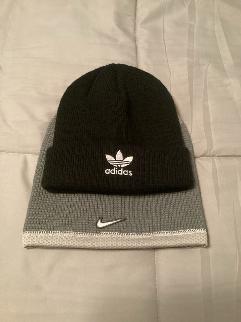 Two beanies, Adidas and Nike.
